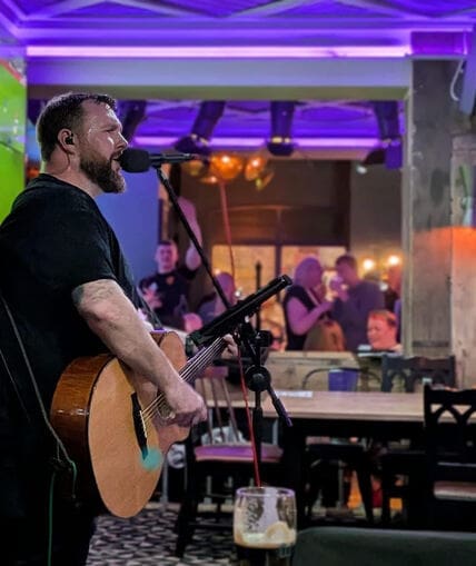 Musical performer on stage with guitar