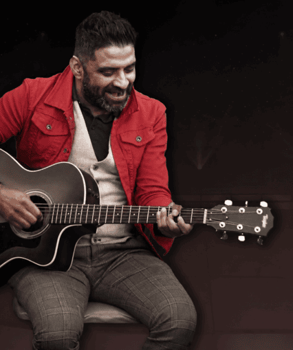 Musical performer on stage with guitar