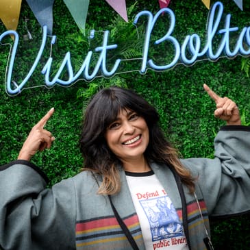 Nisha Katona underneath a sign that says 'Visit Bolton'