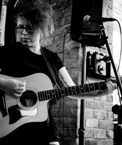 Musical performer on stage with guitar