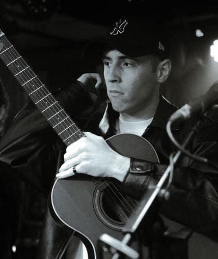 Musical performer on stage with guitar