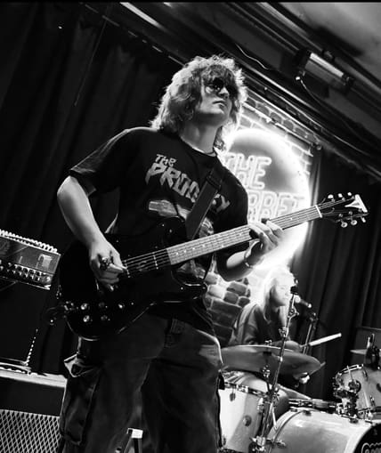 Musical performer on stage with guitar