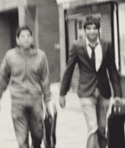 Two musical performers walking