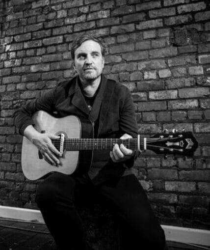 Musical performer on stage with guitar